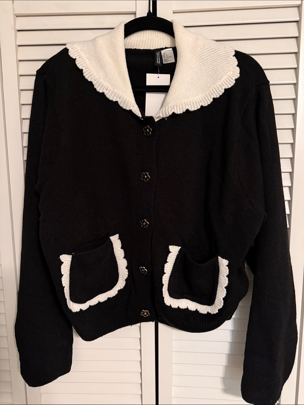 Divided Black Cardigan with White Scalloped Collar and Pocket Trim